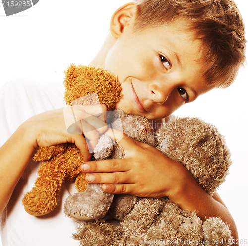 Image of little cute boy with many teddy bears hugging isolated close up