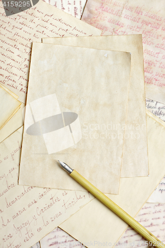 Image of Aged empty paper sheets with vintage nib pen