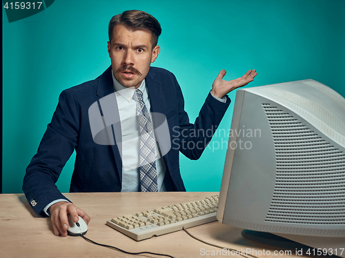 Image of Surprised Young Man Working On computer At Desk