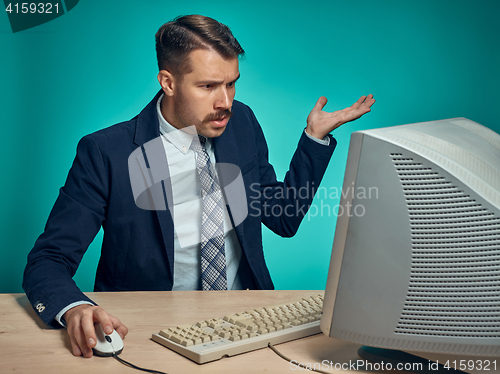 Image of Surprised Young Man Working On computer At Desk