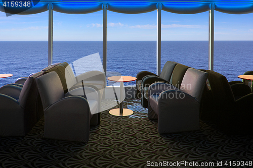 Image of Lounge on a cruise ship, with tables and armchair