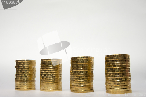 Image of Four stacks of coins on a light background