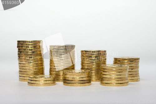 Image of Seven coins columns mounted in two rows showing savings growth