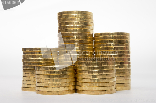 Image of Five stacks of coins of different height on a white background