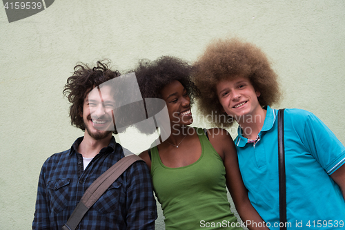 Image of multiethnic group of happy three friends