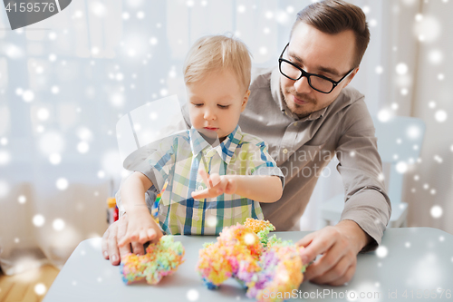 Image of father and son playing with ball clay at home