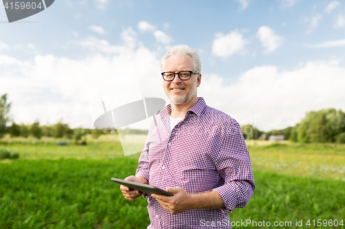 Image of senior man with tablet pc computer at county