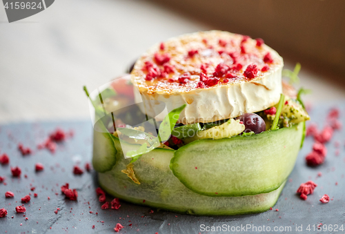 Image of goat cheese salad with vegetables at restaurant