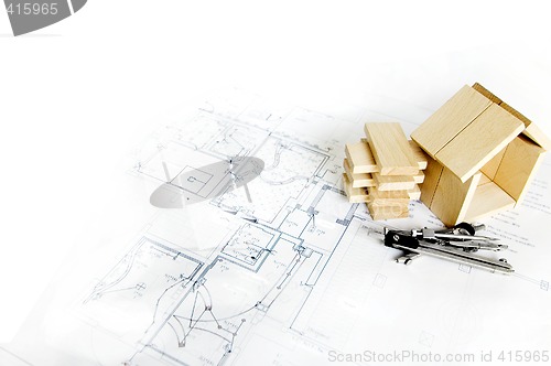 Image of blueprint and wooden model of house