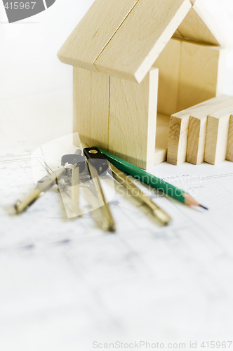 Image of blueprints and wooden model of house