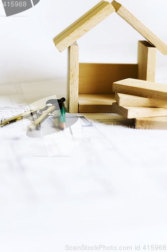 Image of blueprints and wooden model of house