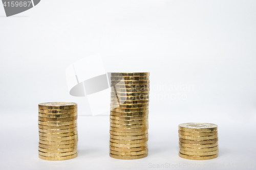 Image of Three columns of coins similar to the podium