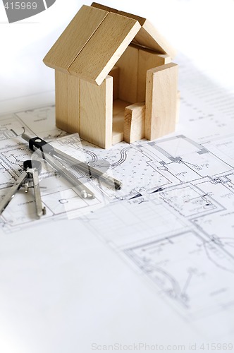 Image of blueprint and wooden model of house