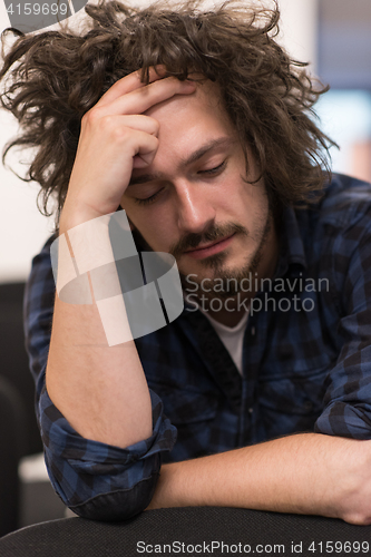 Image of A student sits alone  in a classroom