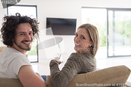 Image of Rear view of couple watching television