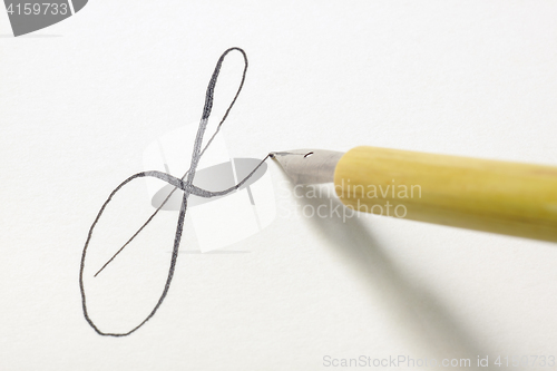 Image of Nib pen tip writing small letter f in a spencerian style