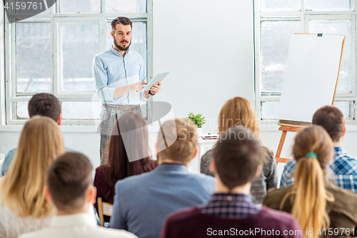 Image of Speaker at Business Meeting in the conference hall.