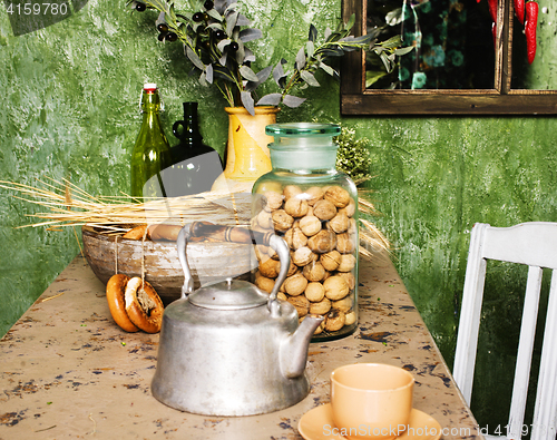 Image of country kitchen with green walls and wood table, rural look