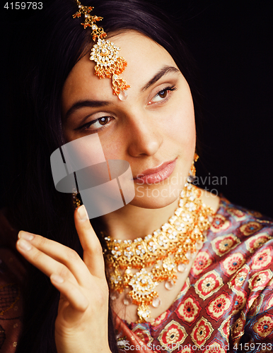 Image of beauty sweet real indian girl in sari smiling on black backgroun