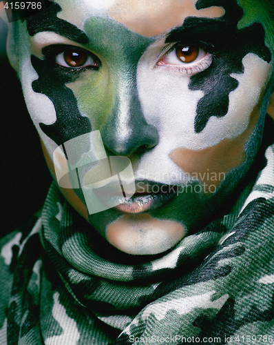 Image of Beautiful young fashion woman with military style clothing and face paint make-up, khaki colors