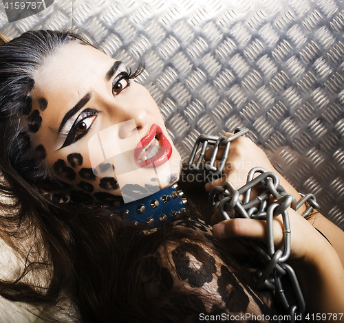 Image of young sexy woman with leopard make up all over body, cat bodyart