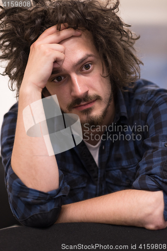 Image of A student sits alone  in a classroom