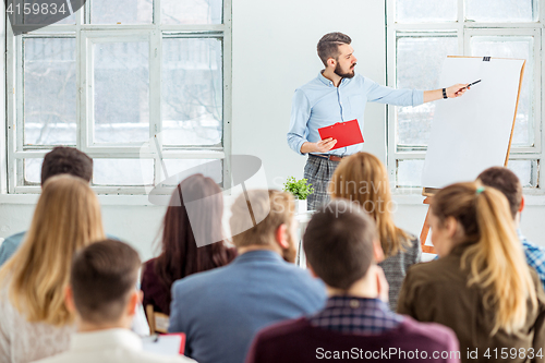 Image of Speaker at Business Meeting in the conference hall.