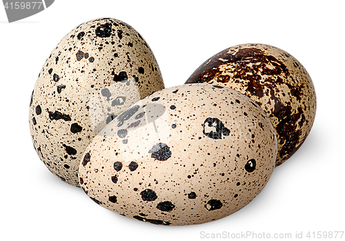 Image of Three quail eggs beside