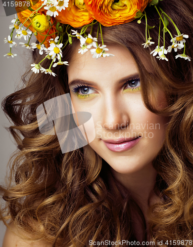 Image of Beauty young woman with flowers and make up close up, real spring beauty