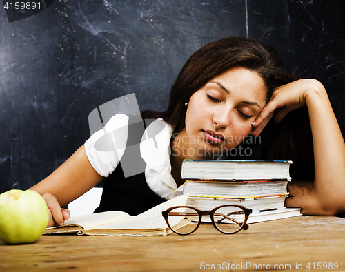 Image of portrait of happy cute student in classroom at blackboard