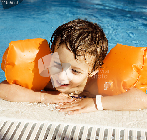 Image of little cute boy in swimming pool