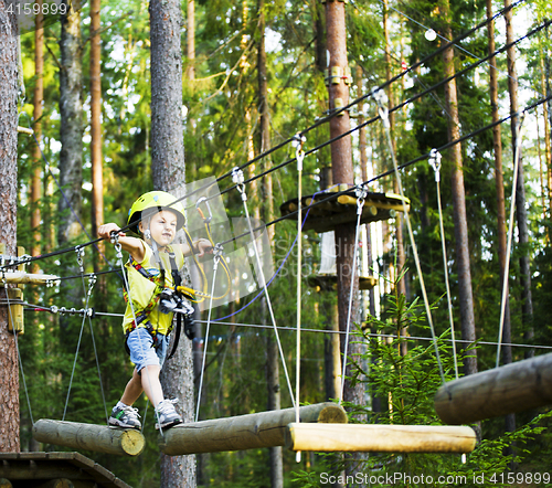 Image of little cute boy in helmet runs track, leisure on nature