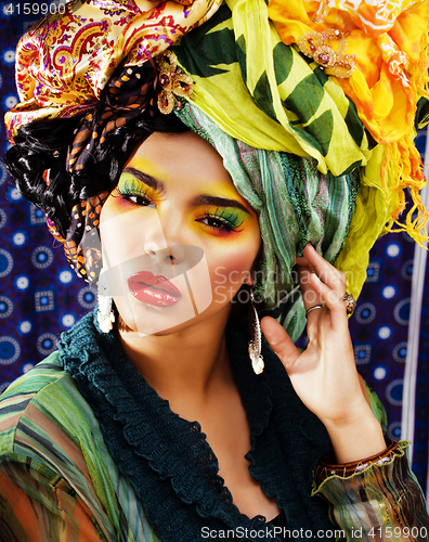 Image of beauty bright woman with creative make up, many shawls on head like cubian woman