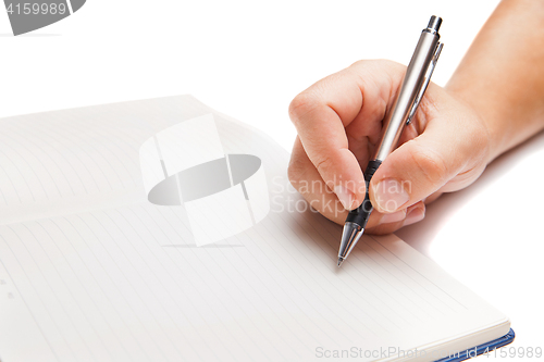 Image of Man hand writing in open book isolated on white