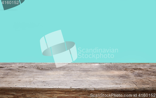 Image of wooden table and blue background