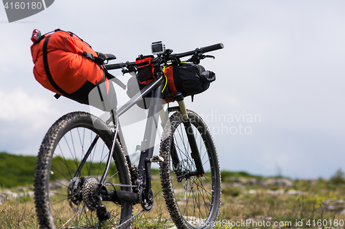 Image of Bicycle with orange bags for travel