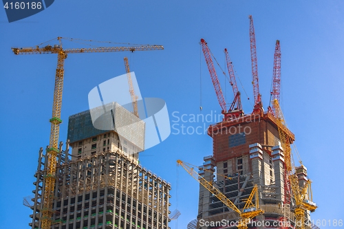 Image of Construction of skyscrapers under blue sky