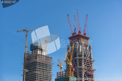 Image of Construction of skyscrapers under blue sky