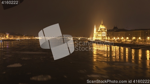 Image of Parliament at nighttime with icy Danube