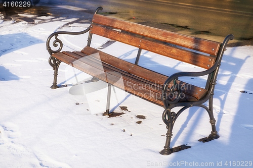 Image of Wooden bench at winter with in the snow