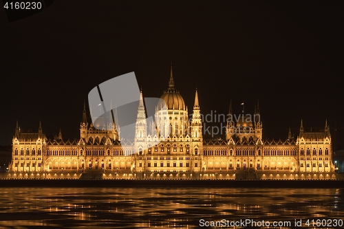 Image of Parliament at nighttime with icy Danube