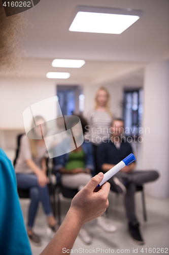 Image of close up of teacher hand with marker