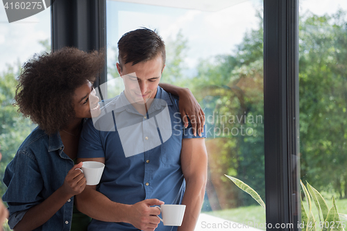 Image of romantic happy young couple relax at modern home indoors