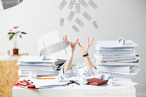 Image of The many crumpled papers on desk of stressed male workplace