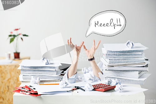 Image of The many crumpled papers on desk of stressed male workplace