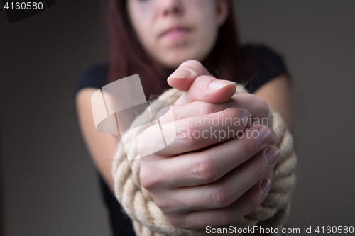 Image of Woman hostage with tied hands