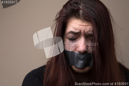 Image of Crying girl with gray tape