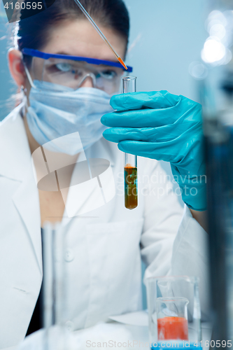 Image of Young researcher handling chemical agents