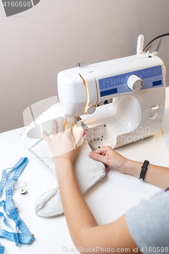 Image of Photo of seamstress with sewing-machine