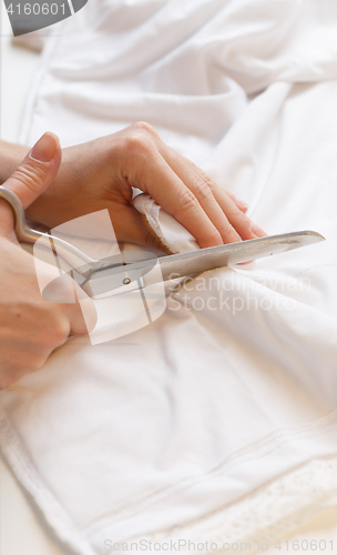 Image of Seamstress tailors with scissors cloth